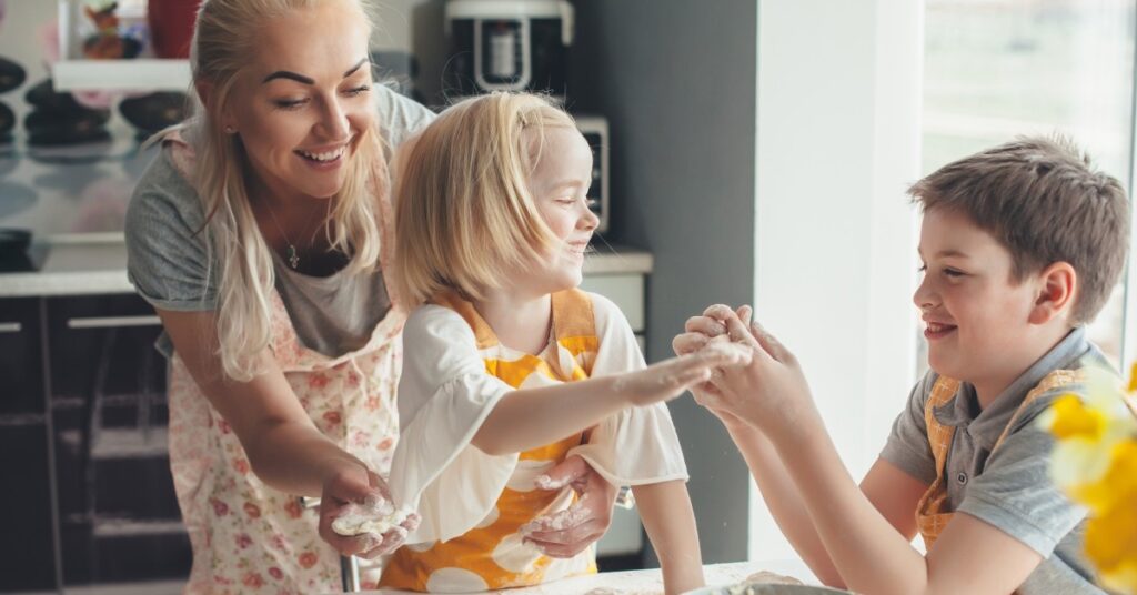 Image of mom and two children baking together.